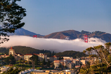 Golden Gate Bridge peeks out from the fog in San Francisco