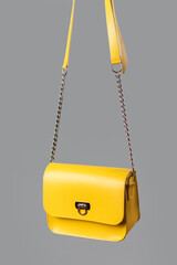 Demonstrating trendy colors 2021 - Gray and Yellow. Fashionable leather bag