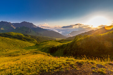 Beautiful mountain landscape at Caucasus mountains with clouds and blue sky