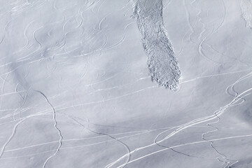 Off piste slope with traces of skis, snowboarding and avalanche