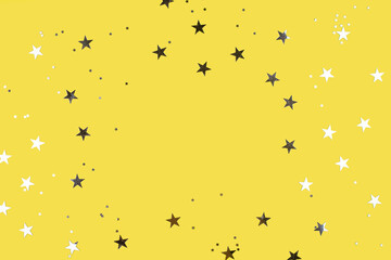 Obraz premium Gray silver stars on yellow background. Flat lay, top view. Colors of year. Copy space, frame