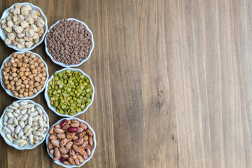 A selection of dried pulses legumes and copy space