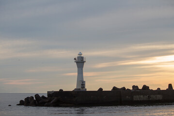 The dim sky at dusk and the lighthouse at Kushiro Port