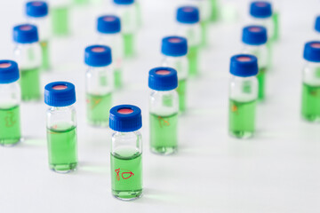 Pattern from HPLC glass vials with green fluid. Pharmaceuticals and chemical analysis.