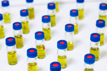 Pattern from HPLC glass vials with yellow fluid. Pharmaceuticals and chemical analysis.