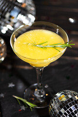 Mimosa coctail with orange juce and champagne in trendy colors gray and Illuminating yellow of the 2021. New Year or Birthday party with a mirror disco balls.