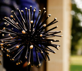 art metalwork of a spiked flower head  black and cream