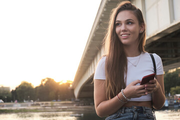 Fototapeta premium Beautiful teenage girl looking at her phone
