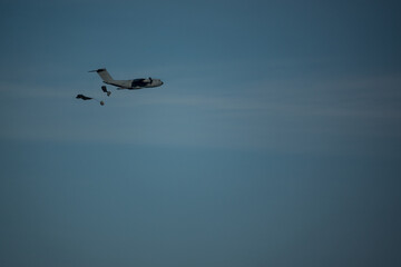 airbus a400m transporter aircraft releasing cargo on parachute
