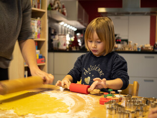 Little girl baking with her mother