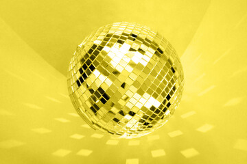 Large disco ball on a red background with highlights and reflection.