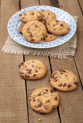 Chocolate chip cookies on a plate over a wooden table