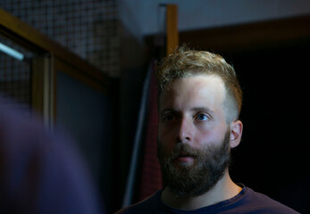 man in front of the bathroom mirror