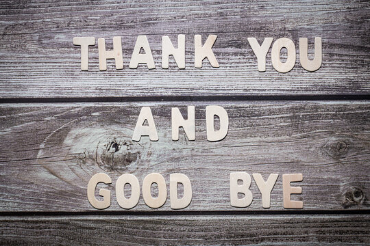 Thank you and good bye wooden words letter written on a wooden board