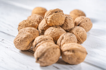Walnuts kernels on white wooden desk, stock photo