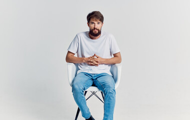 bearded man in white t-shirt near chair lifestyle isolated background