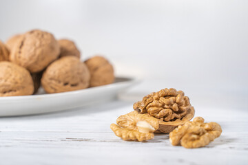 Walnuts kernels on white wooden desk, stock photo