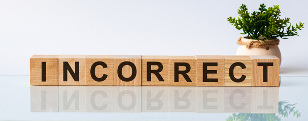 Incorrect motivation text on wooden blocks business concept white background. Front view concepts,...