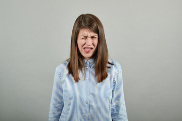 Fooling around outside, sticks out tongue as a sign of disobedience, protest and disrespect. Human...