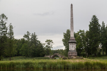 Stone pillar monument in summer green park