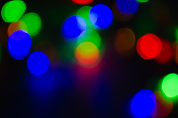 Abstract pattern of colorful bokeh lights on dark background