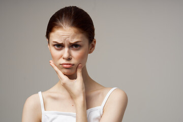 woman in white t-shirt holds hand of owner toothache emotion model