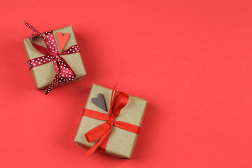 Two gift boxes with bows over a red background. Valentine's Day. 