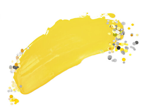 Brushstroke of illuminating yellow paint and ultimate gray confetti isolated on white background. Creative background toned in main color of the year 2021. Copy space for text.
