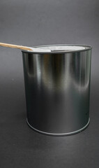 can of white paint, stirring with palette, top view black background.