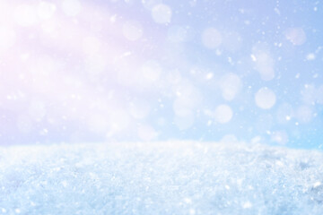 Abstract Christmas blue background with sun rays, flying snow. Merry Christmas. Happy new year.