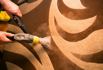 The process of cleaning carpets with a steam vacuum cleaner. An employee of a cleaning company...