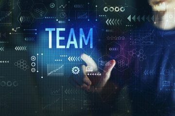 Team with young man touching screen at night