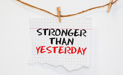 stronger than yesterday white chalk text on a vintage slate blackboard