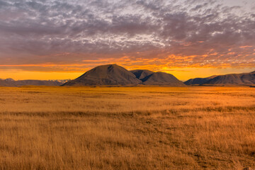 The mountains and dry tussock covered valley floor at Hakatere Conservation park in the Ashburton...