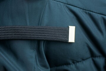 one black long harness on a dark green cloth