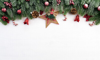 Fototapeta na wymiar Christmas branches decoration concept with berries, stars and pine cones on white wooden background. Flat lay, top view with copy space.