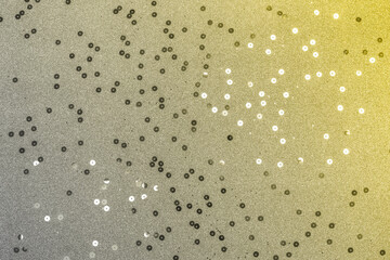 Beautiful yellow-gray background with metallic confetti. Holiday decoration concept. Color 2021.