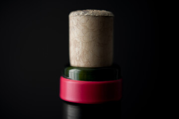 Uncorked red wine bottle with black background