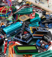 Fototapeta na wymiar The electronic components of Arduino microcontrollers and programmers are piled up.Selective focus