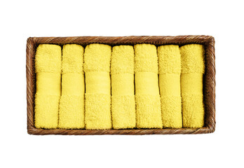 Yellow towels in basket isolated over white