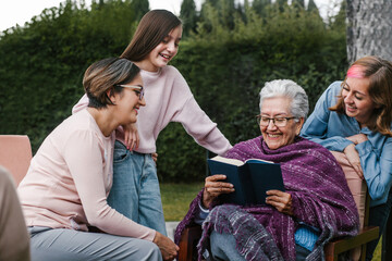 latina women family reading a book in a backyard outside home in Mexico city
