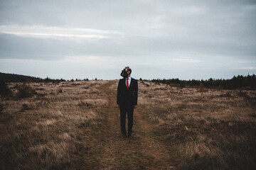 man wearing a gas mask in a field