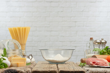 The glass bowl with flour for preparing dough on white background. Backstage of cooking pasta alla carbonara. Traditional italian dish. Cooking process concept. Cookbook illustration.