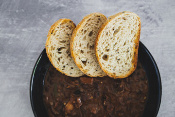 plant-based food, vegan brazilian feijoada with beans and plant-based meats with toasted bread slices
