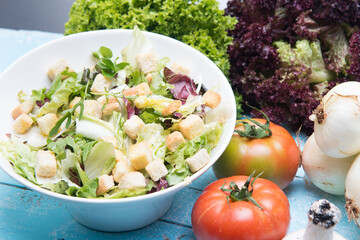plate of caesar salad with bread and fresh lettuce