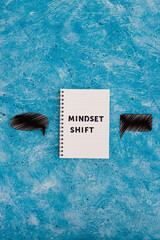 positivity and law of attraction, notepad with Mindset Shift text with different thought bubbles...
