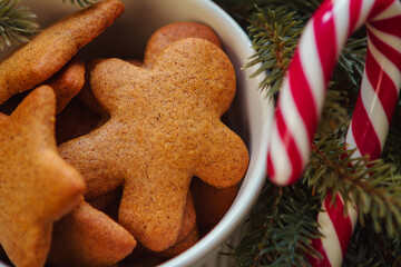 Christmas gingerbread men and stars, cookies in a white bowl, close up