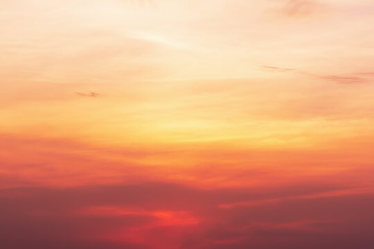 A view of the sky at sunset in vibrant orange pinks and violet colors.