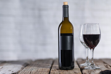 Elegant bottle and glasses with red wine on white background. Advertising and promotion concept. Studio photo.