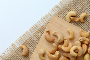Cashew nuts with salt on wooden board